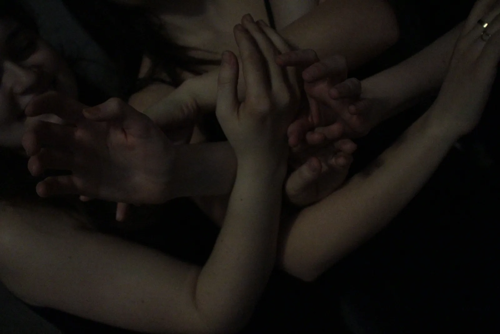 The company's hands clasped together in a tight cluster.